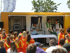 Mass being said under the awning of a trailer
